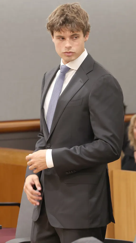 Fraser Bohm in a dark suit and light blue tie at a bail hearing.