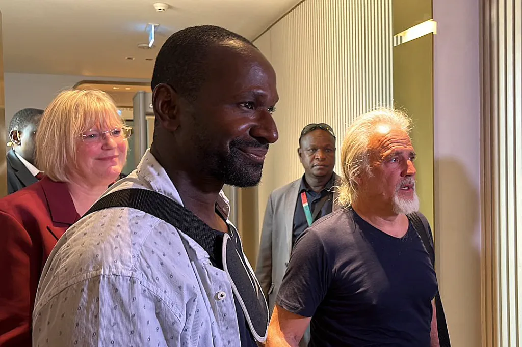 French journalist Olivier Dubois and US national Jeffery Woodke, freed after being kidnapped, arriving at Diori Hamani International Airport.