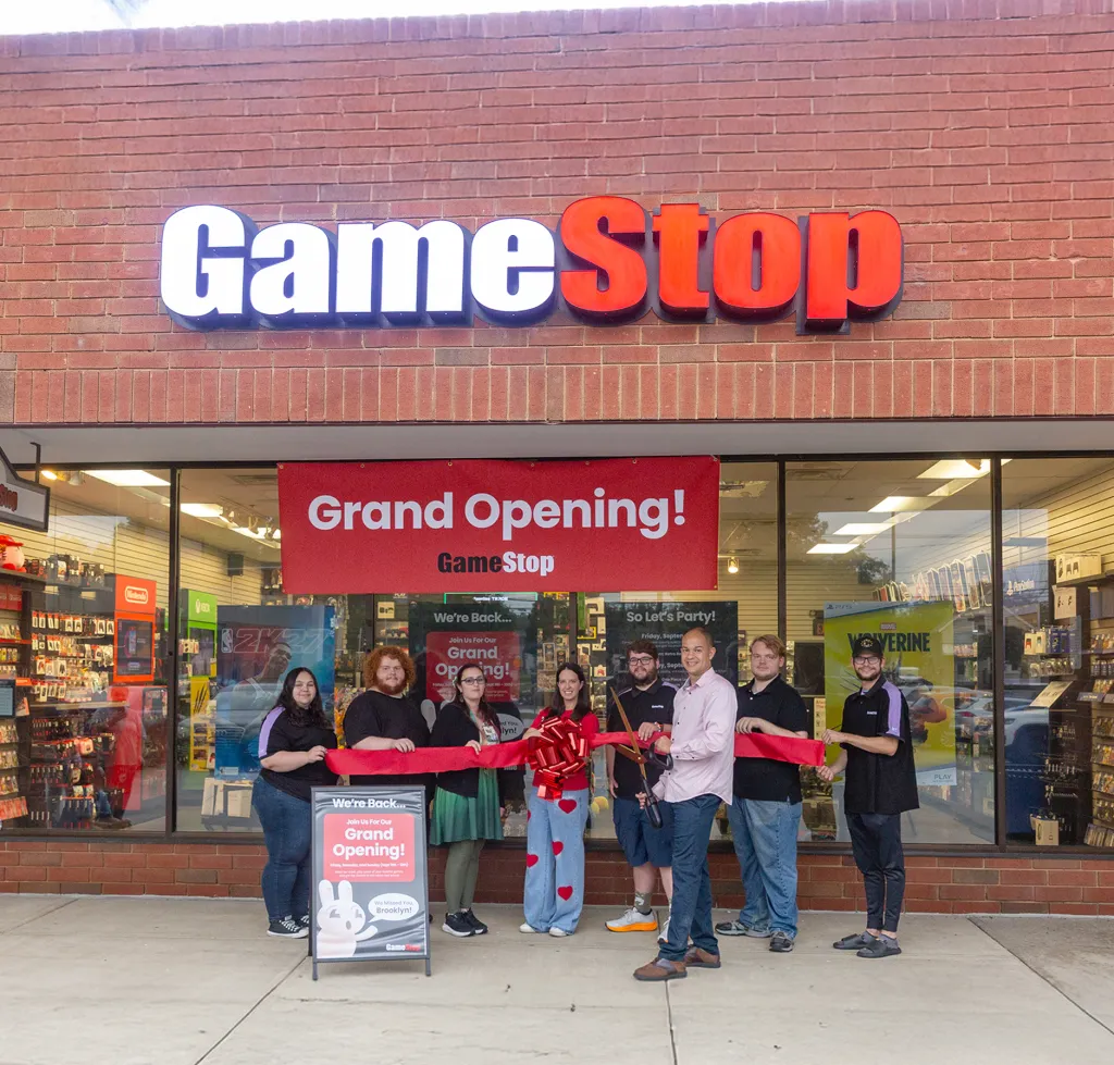 People gather outside a GameStop store for its grand reopening.