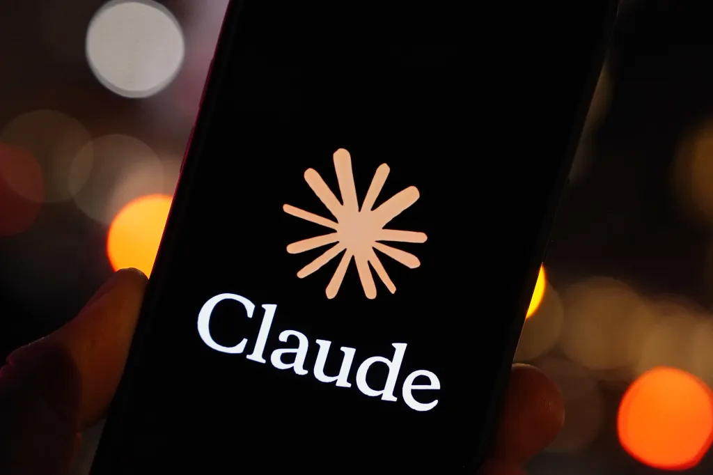 A general view of a Claude logo is displayed on a smartphone.