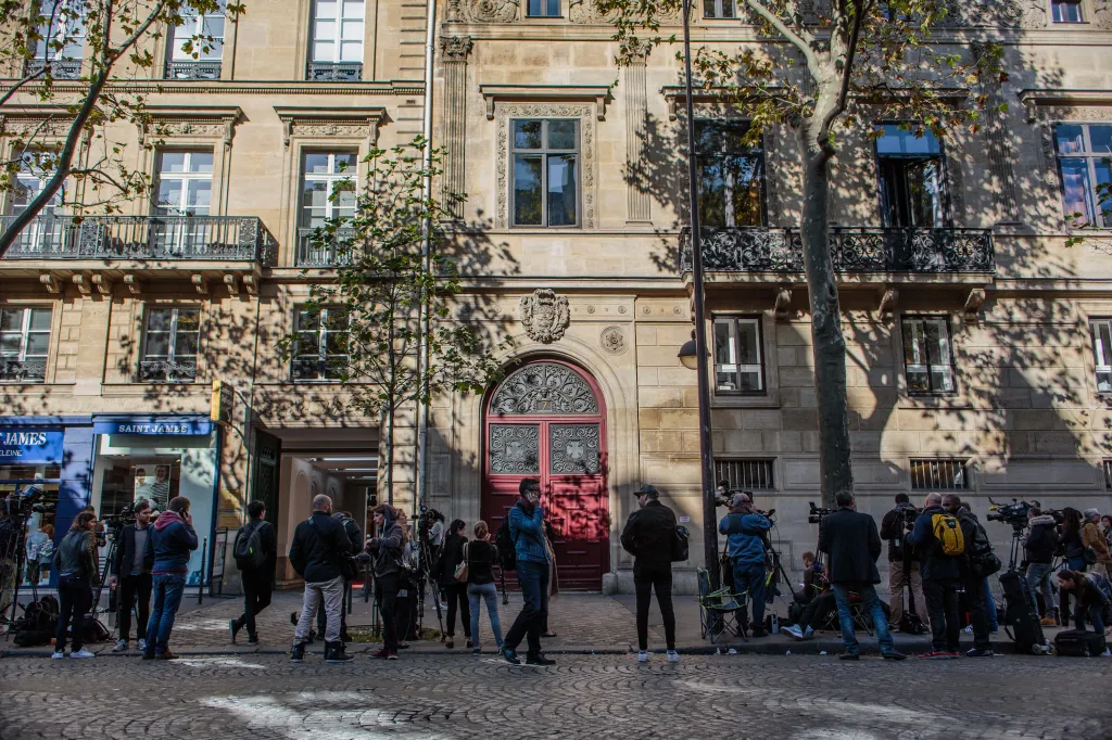 Exterior of Hotel de Pourtales, Kim Kardashian's luxury apartment in Paris, surrounded by numerous media personnel and cameras.