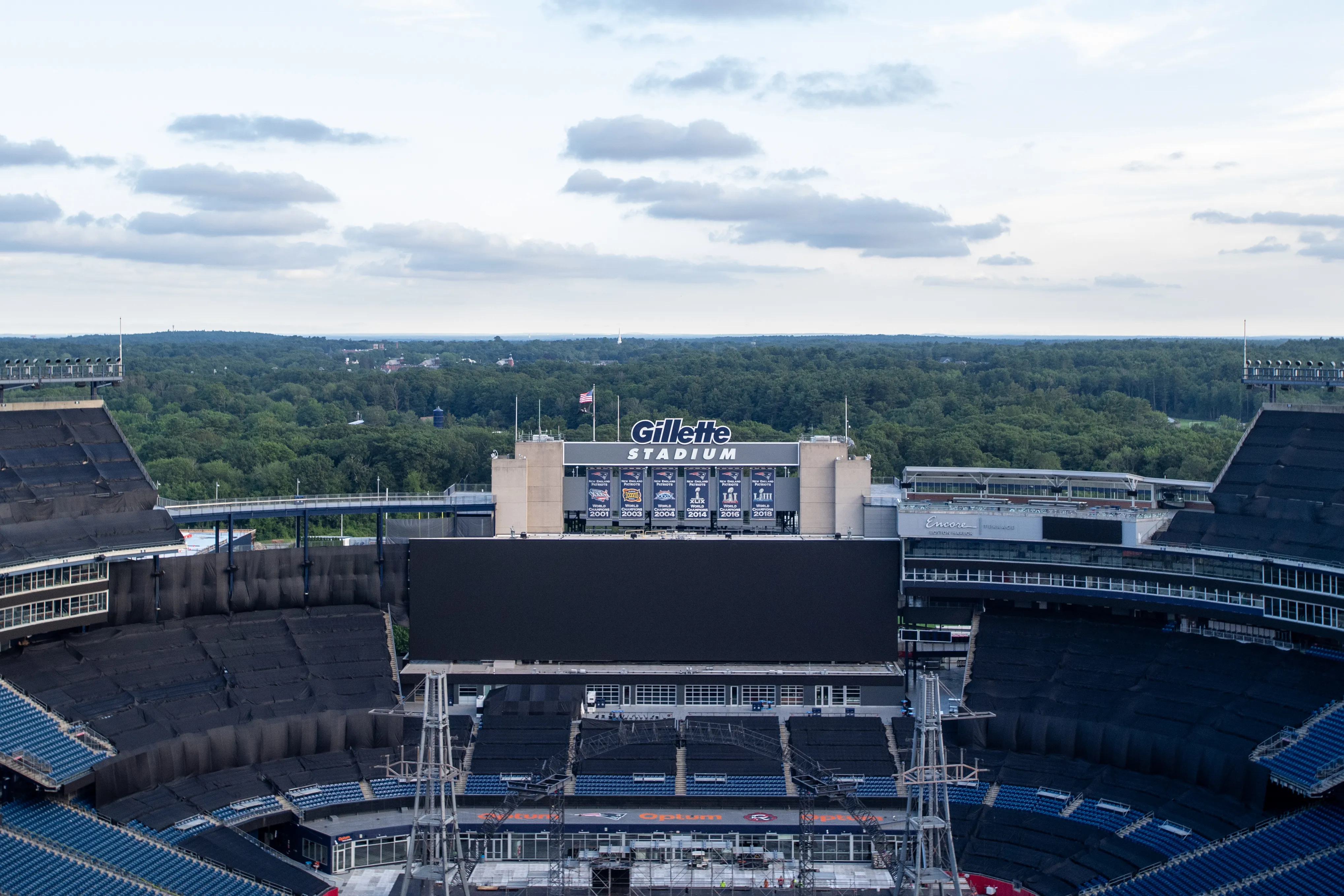 Gillette Stadium, with banners showing World Championship years, during concert setup.