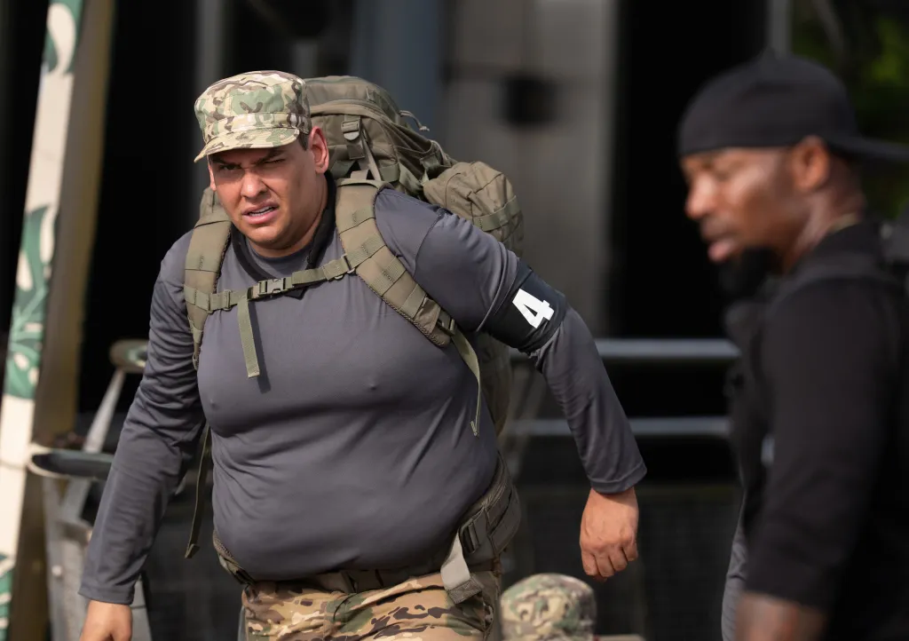 George Santos carrying a heavy pack on