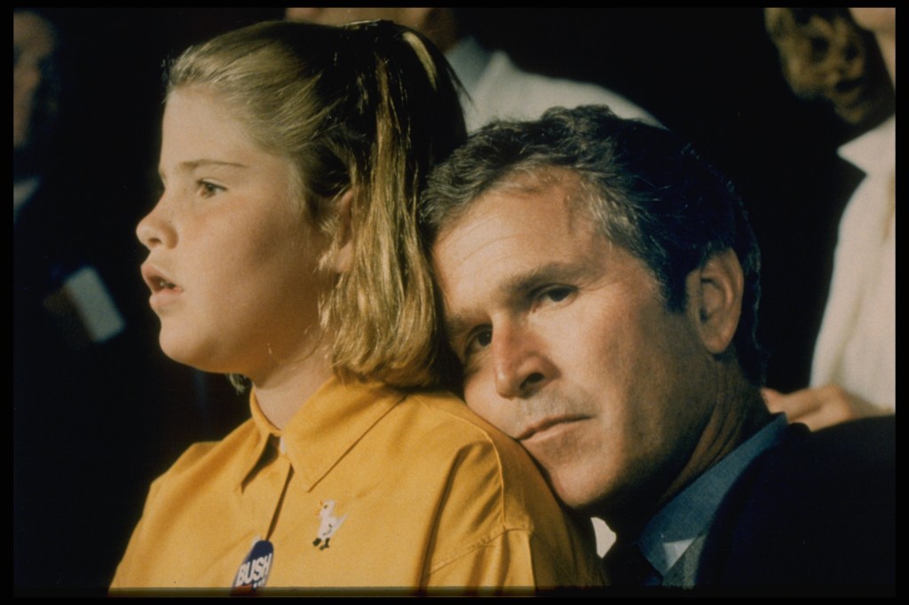 George W. Bush rests his head on his daughter Jenna's shoulder at the Republican Convention in Houston.