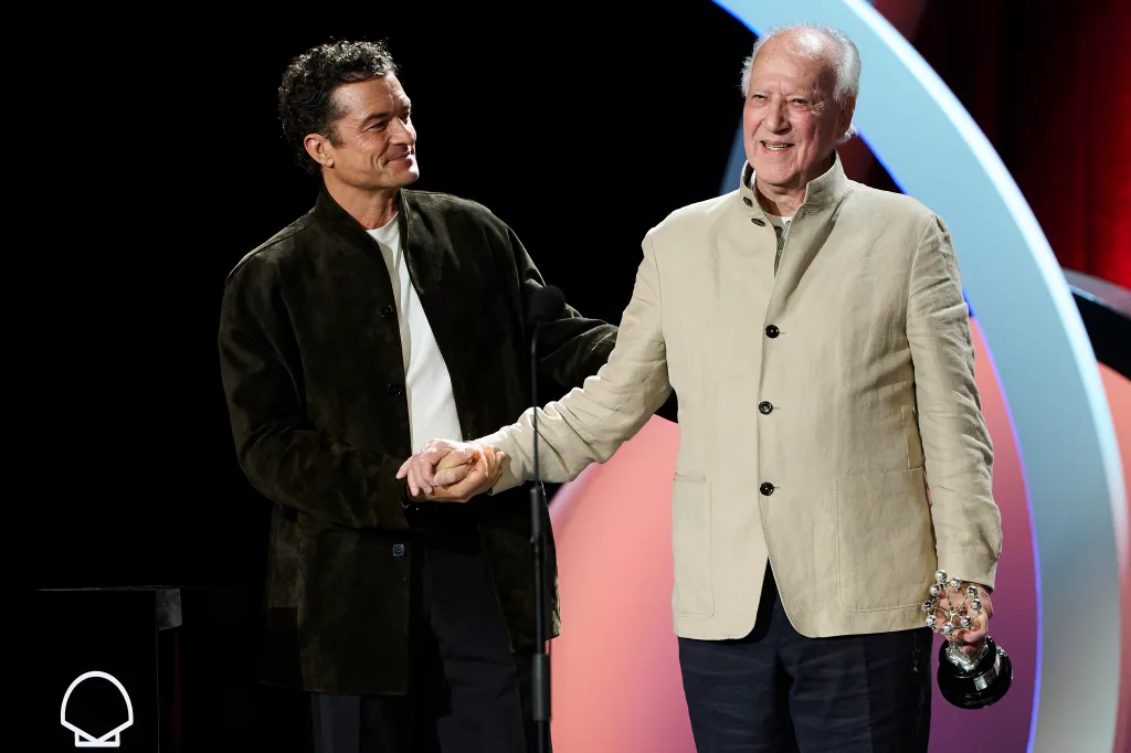 Werner Herzog receives the Donostia Award from Orlando Bloom at the 74th San Sebastian International Film Festival.