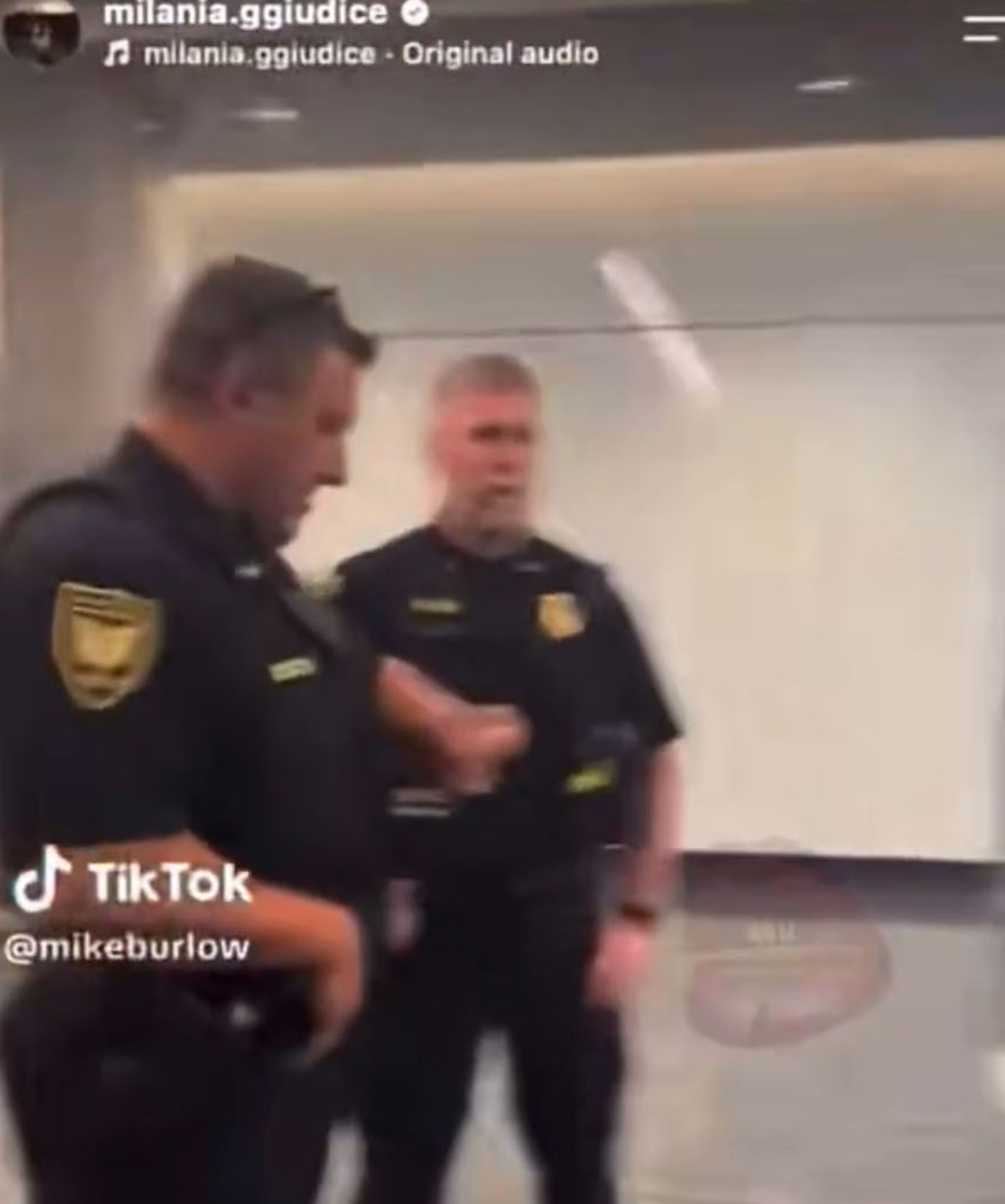 Two male police officers in uniform.