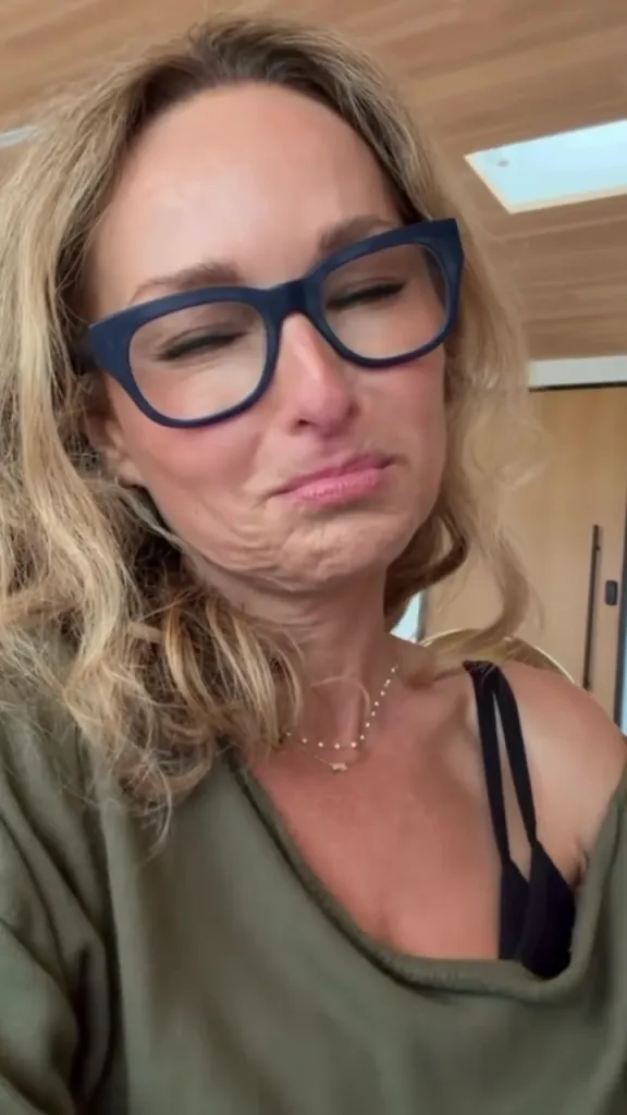 Giada De Laurentiis in glasses, grimacing with her eyes closed.