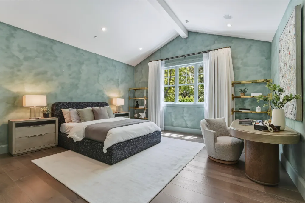 A bedroom with a study/work area