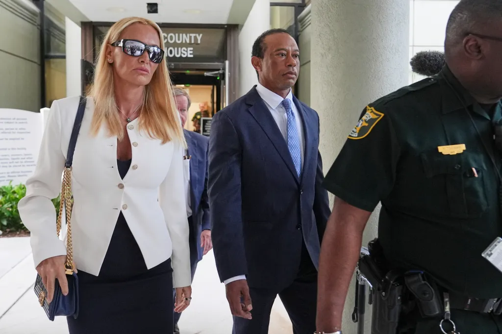 Golfer Tiger Woods leaves with Vanessa Trump and a sheriff's deputy after a DUI plea conference.
