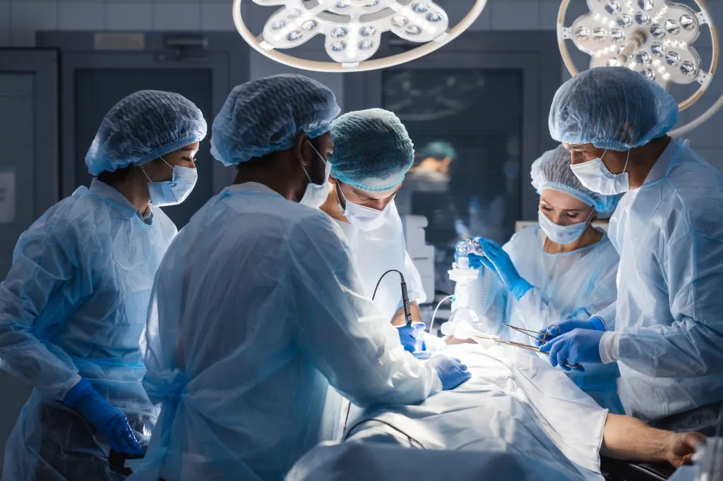 Surgeons perform a complex operation in a hospital operating room.
