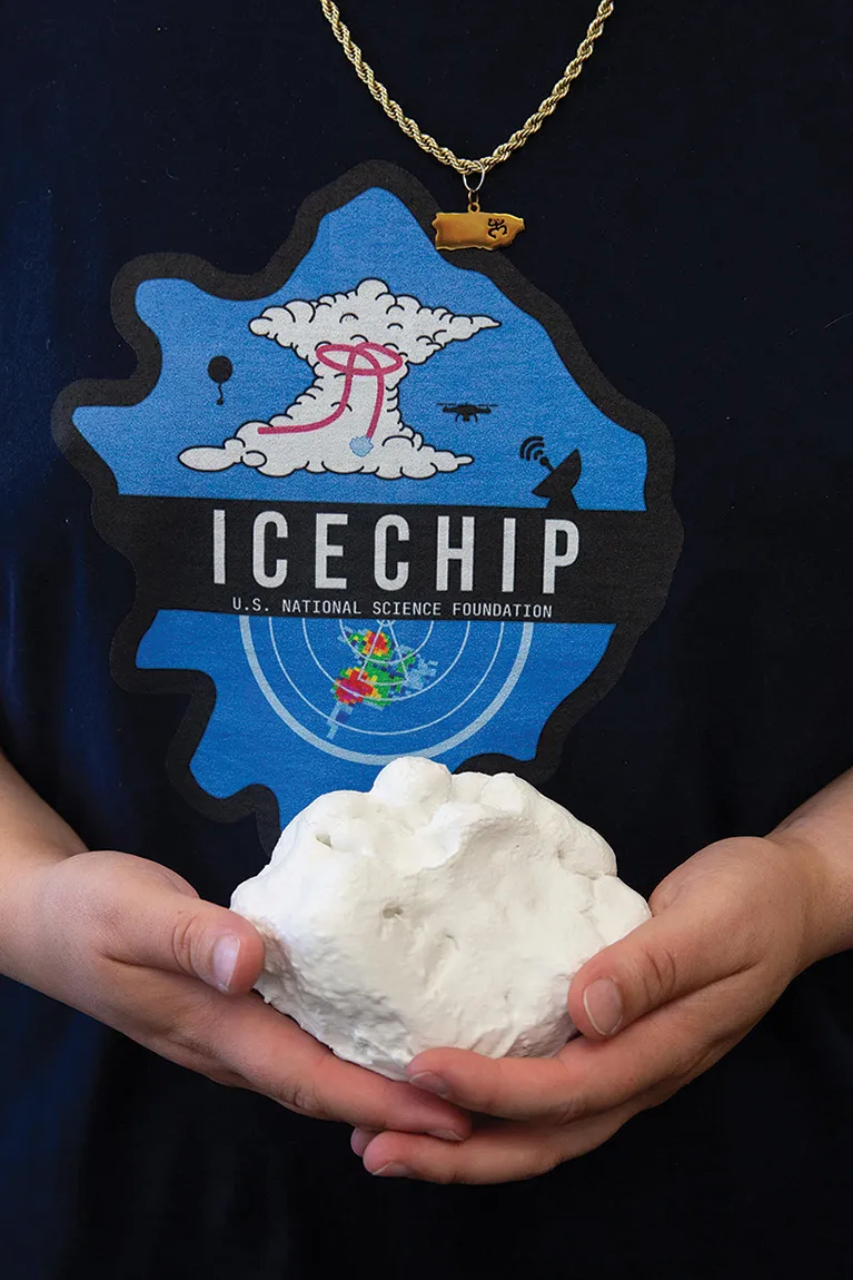 Bernal Ayala holds a 3D-printed replica of one of the largest hailstones in the ICECHIP archive