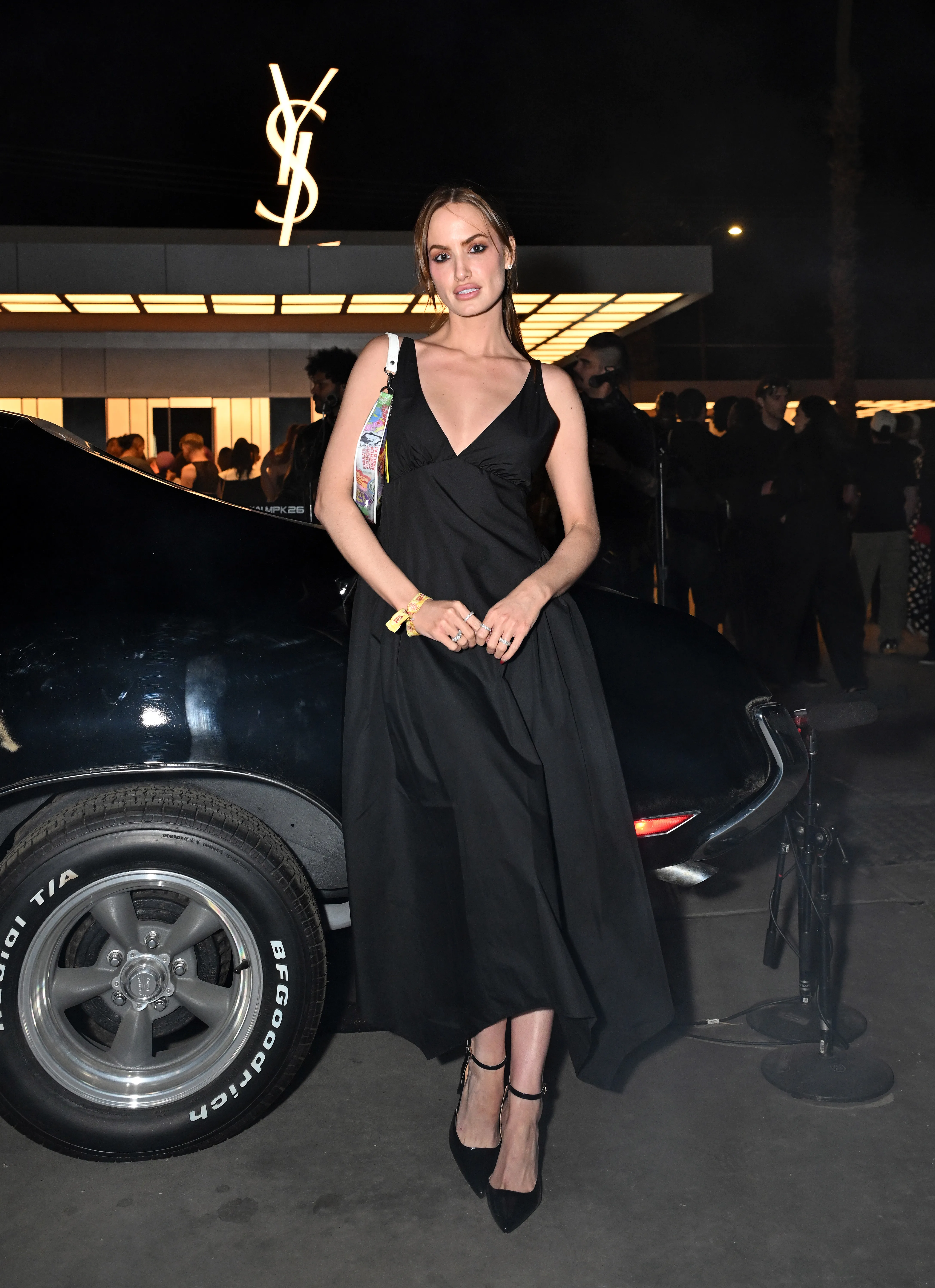 Haley Kalil standing beside a car at the YSL Beauty Drive-Thru & Beauty Stage.