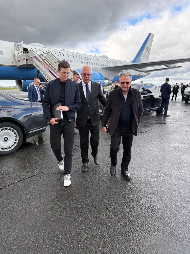 Jared Kushner, Kirill Dmitriev, and Steve Witkoff walk on an airport tarmac after arriving in Moscow to discuss conflict between Russia and Ukraine.