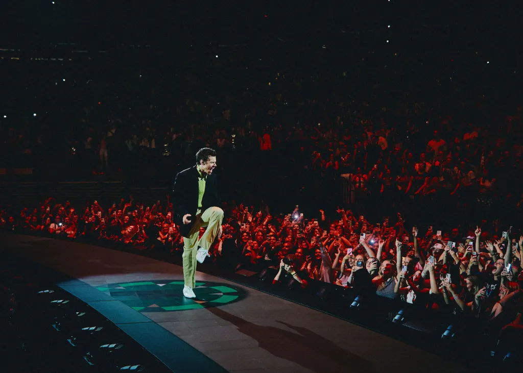 Harry Styles performing on stage to a crowd at Madison Square Garden.