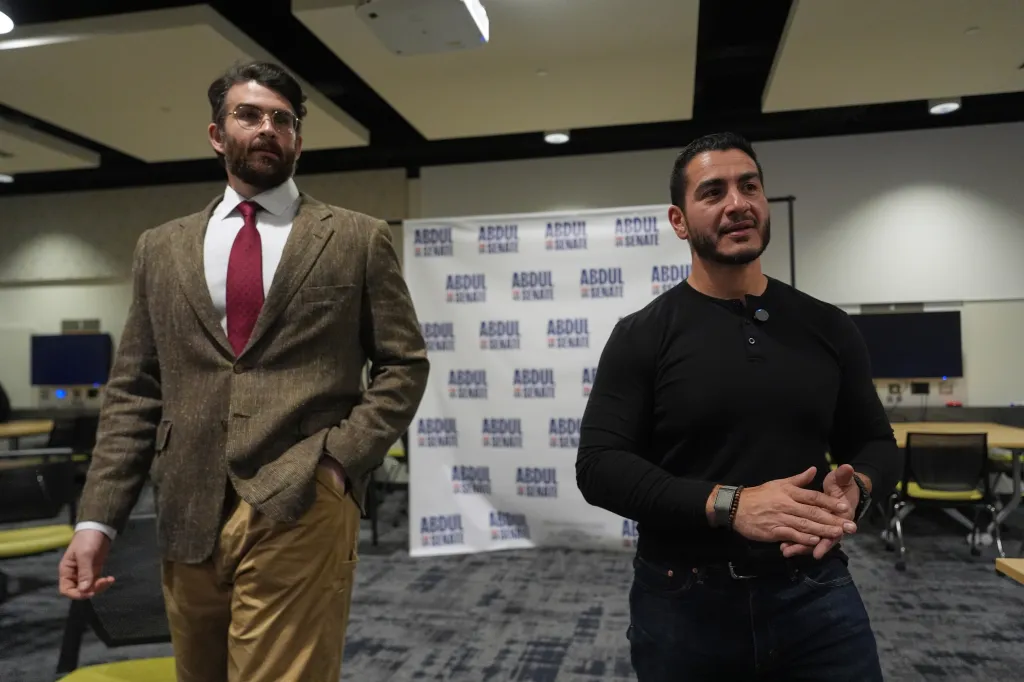 Piker (L) listens as Abdul El-Sayed, a progressive candidate in the Democratic primary for US Senate in Michigan, speaks in a green room before a campaign rally, on April 7, 2026, at the University of Michigan in Ann Arbor, Mich.