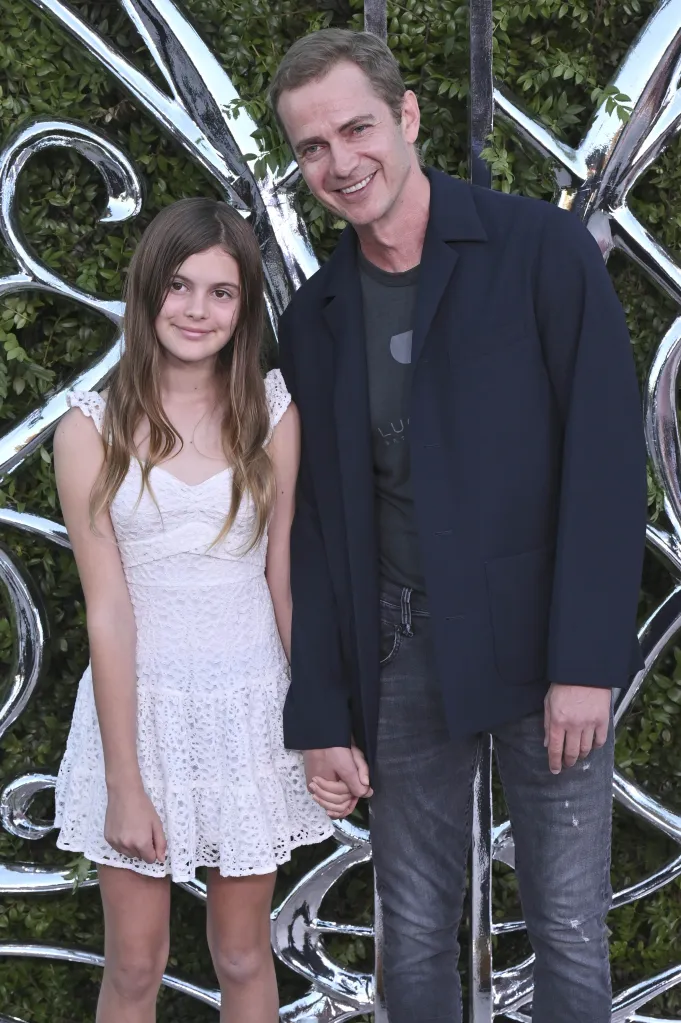 Hayden Christensen and Briar Rose holding hands at an event.