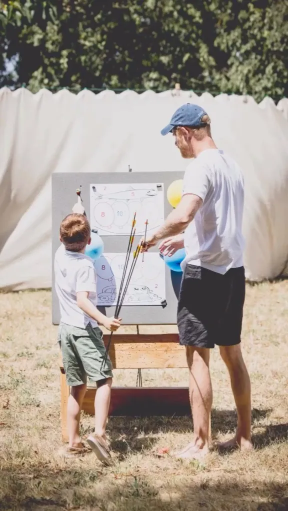 Prince Harry and Prince Archie doing archery together.