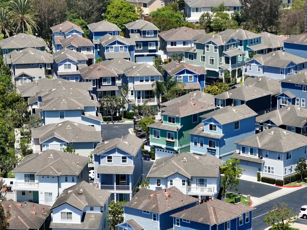 Aerial view of single-family homes and multi-family homes near the intersection of Main Street and Garfield Avenue in Huntington Beach, California.
