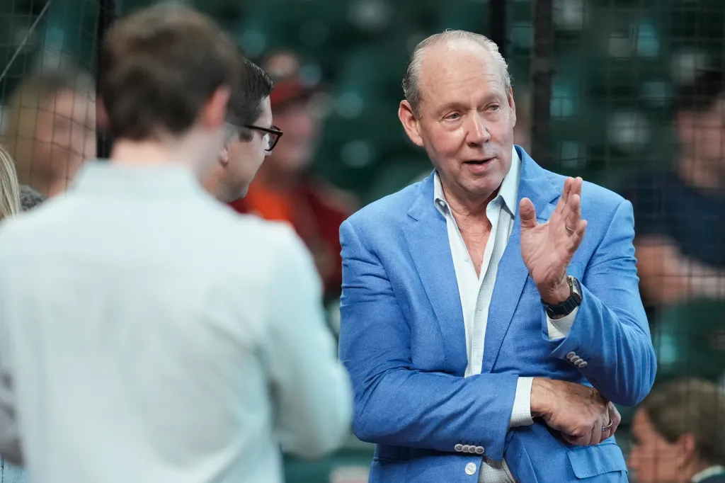 Houston Astros owner Jim Crane speaks to another person.