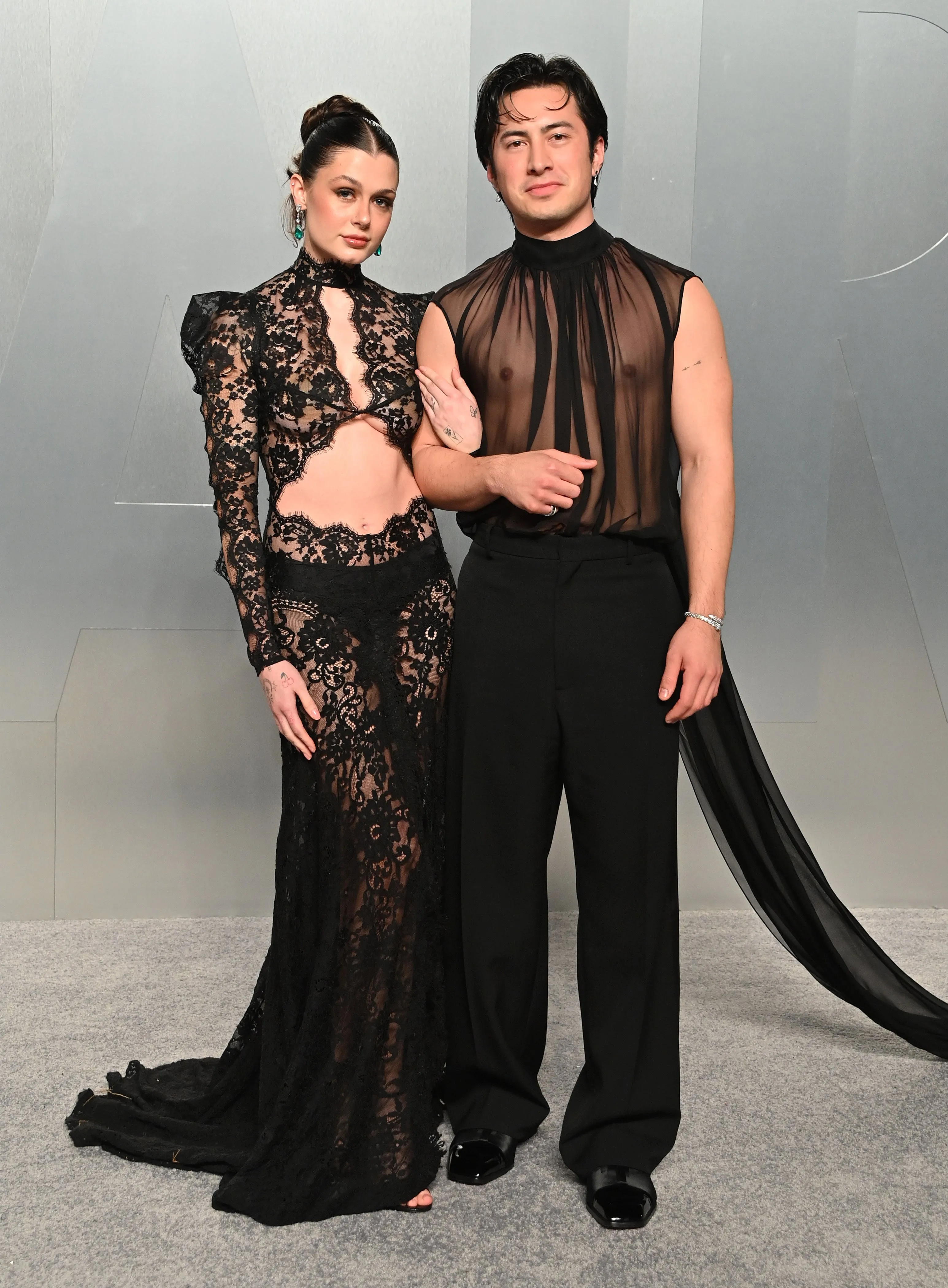 Katelyn Larson and Hudson Williams posing on the red carpet at the Vanity Fair Oscar Party 2026.