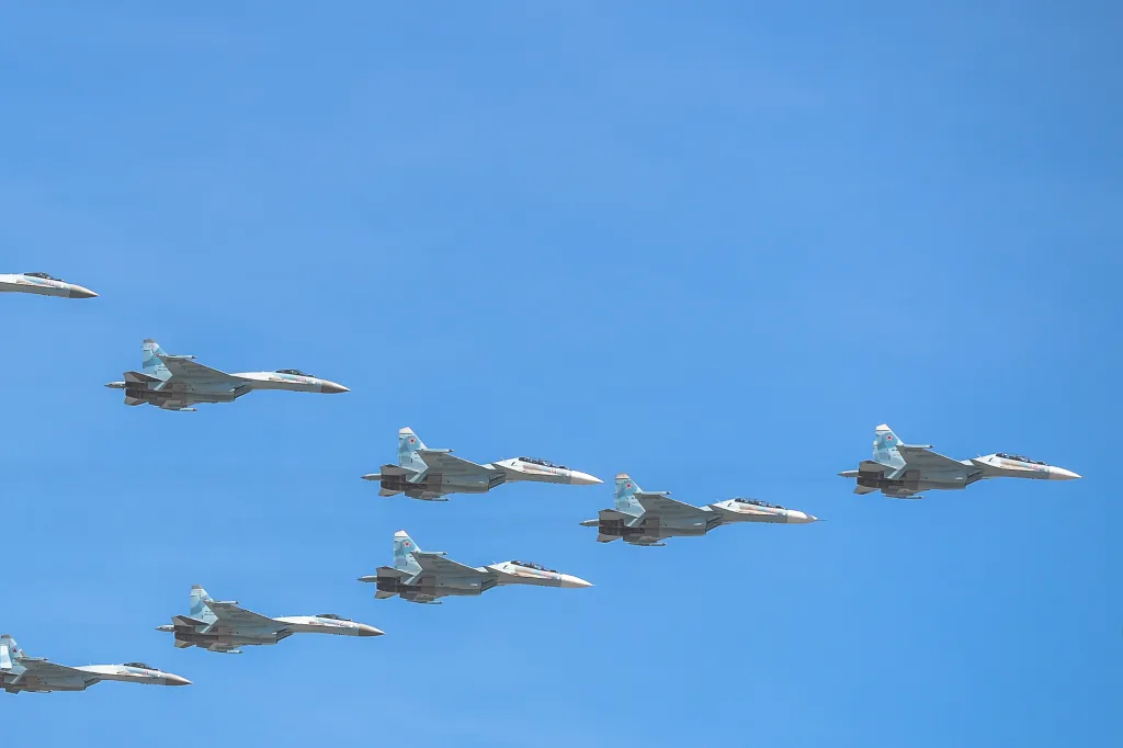Russian Sukhoi Su-30 multirole fighter aircraft fly over Red Square.