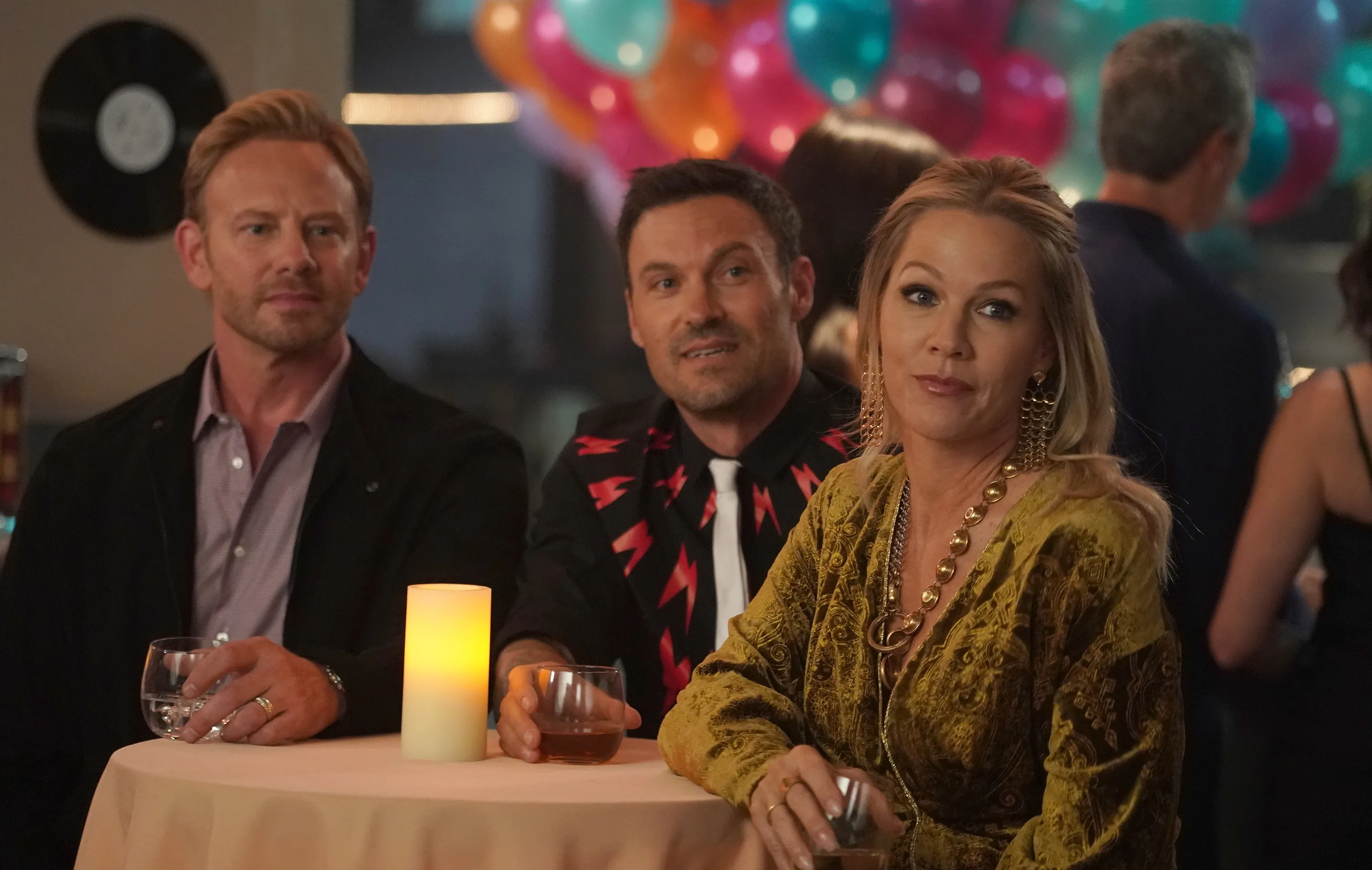 Ian Ziering, Brian Austin Green, and Jennie Garth from BH90210 sit at a table.