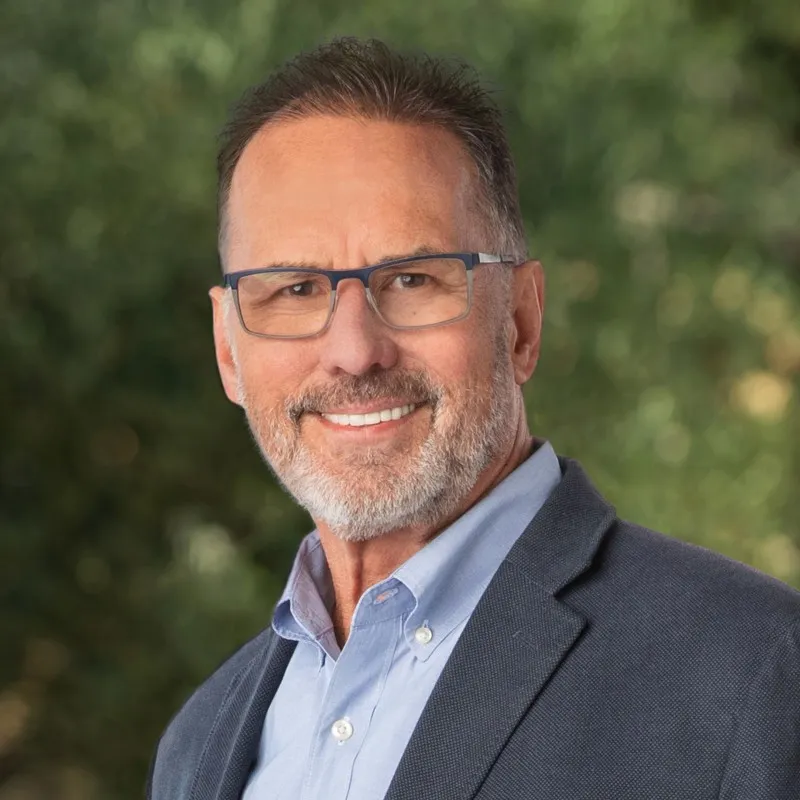 Headshot of Arthur Layne Lundeen, a man with glasses and a beard smiling.