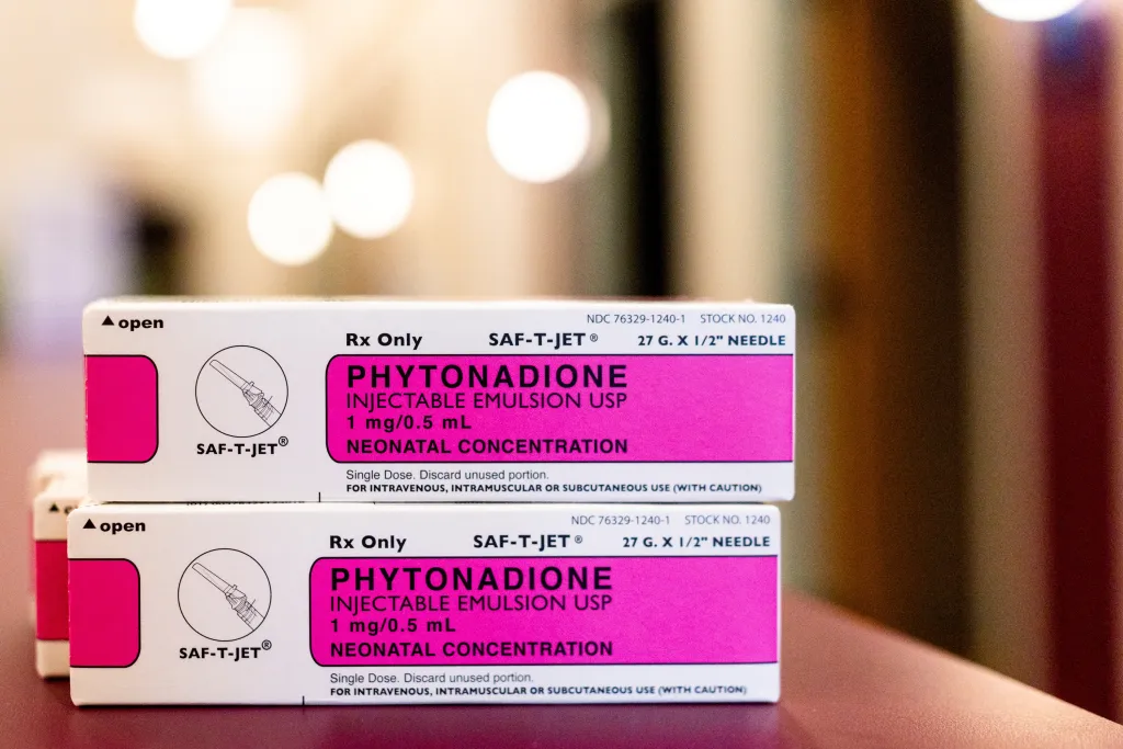 Illustration of two boxes of Phytonadione, a synthetic version of Vitamin K, in neonatal concentration.