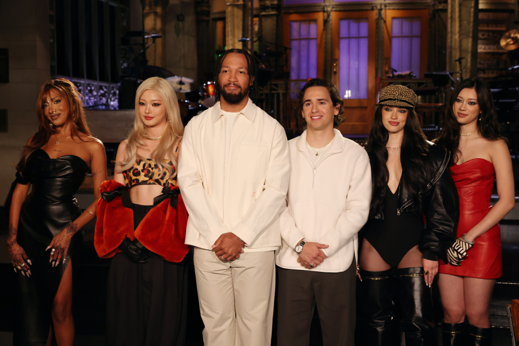 Jalen Brunson and Marcello Hernández pose with members of the musical group Katseye.