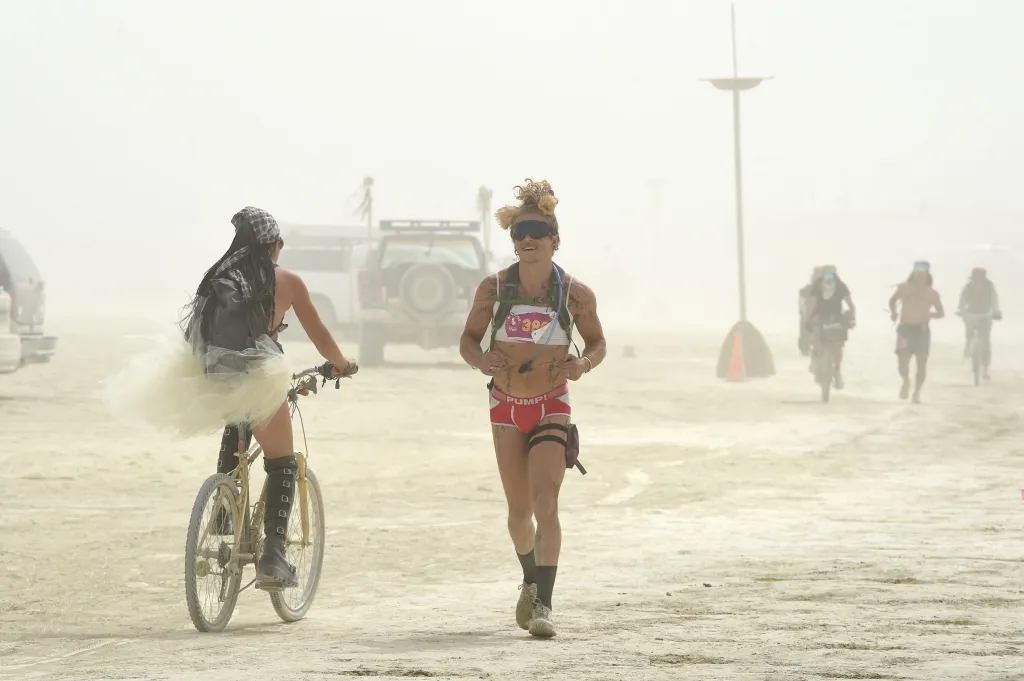 People in costumes on the dusty Black Rock Desert at Burning Man.