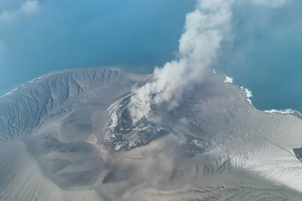 Aerial view of Mount Anak Krakatau spewing volcanic smoke into the Sunda Strait.