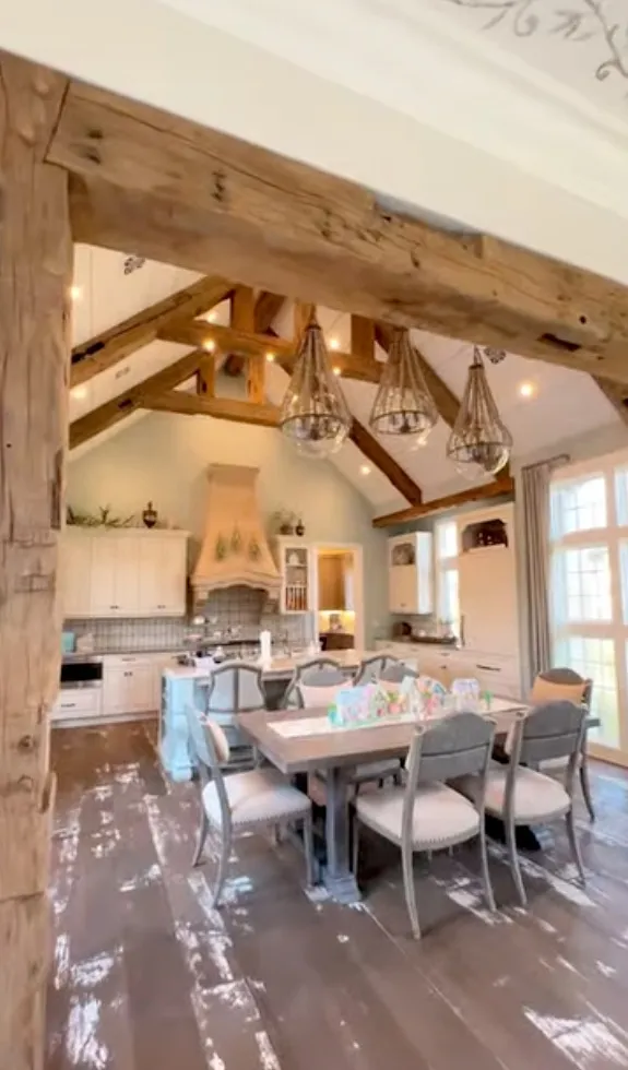 Exposed wood beams and rustic finishes continue the fairy-tale aesthetic inside the home.