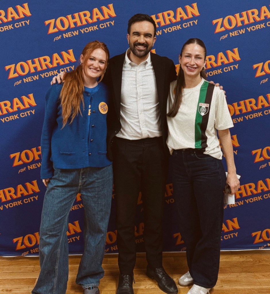 Megan Klink and Mayor Mamdani posing with another woman in front of a 