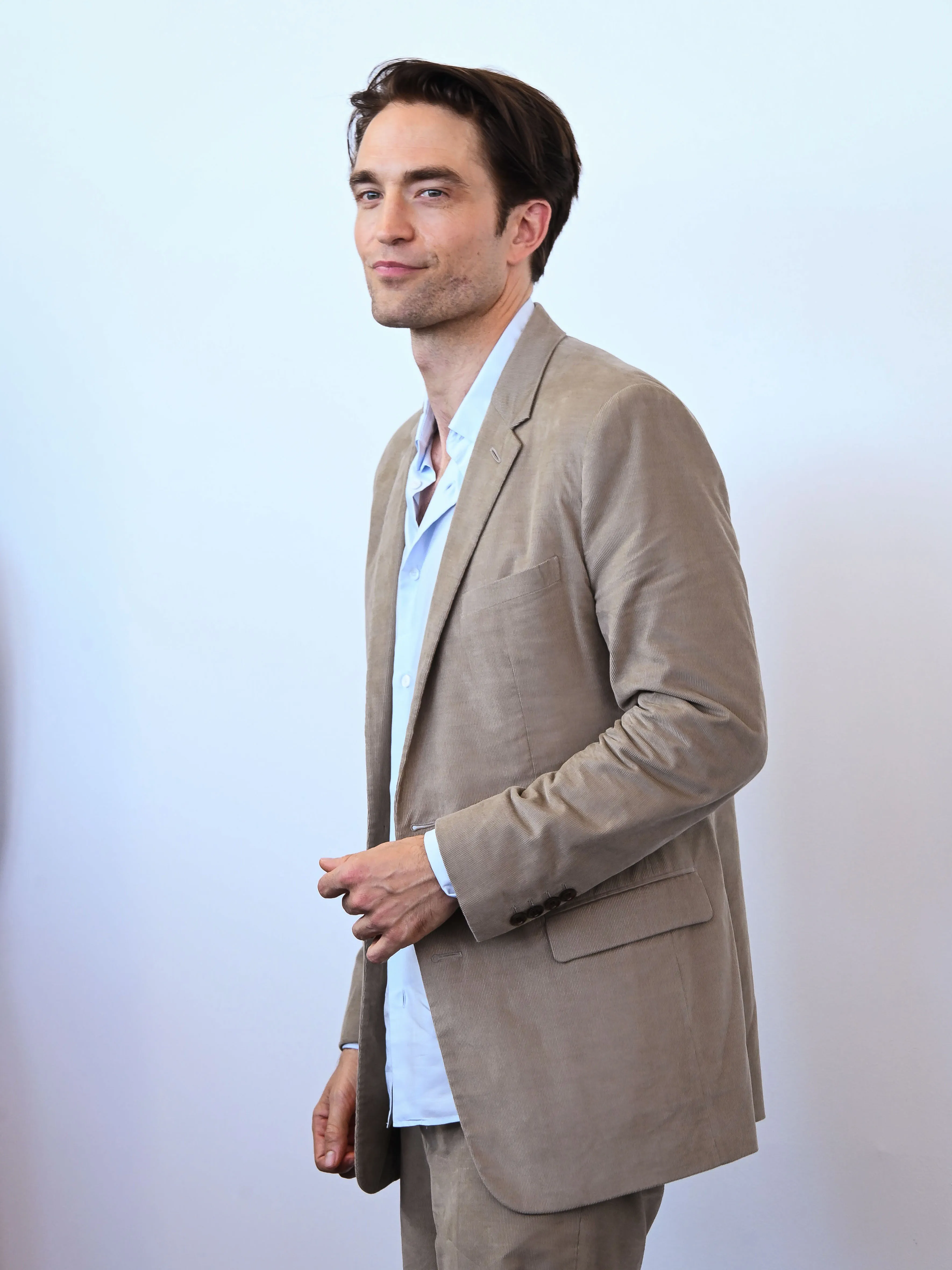 Robert Pattinson smiling during a photocall for