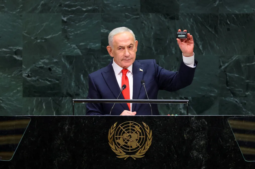 Israeli Prime Minister Benjamin Netanyahu holds up a pager at the 81st United Nations General Assembly.