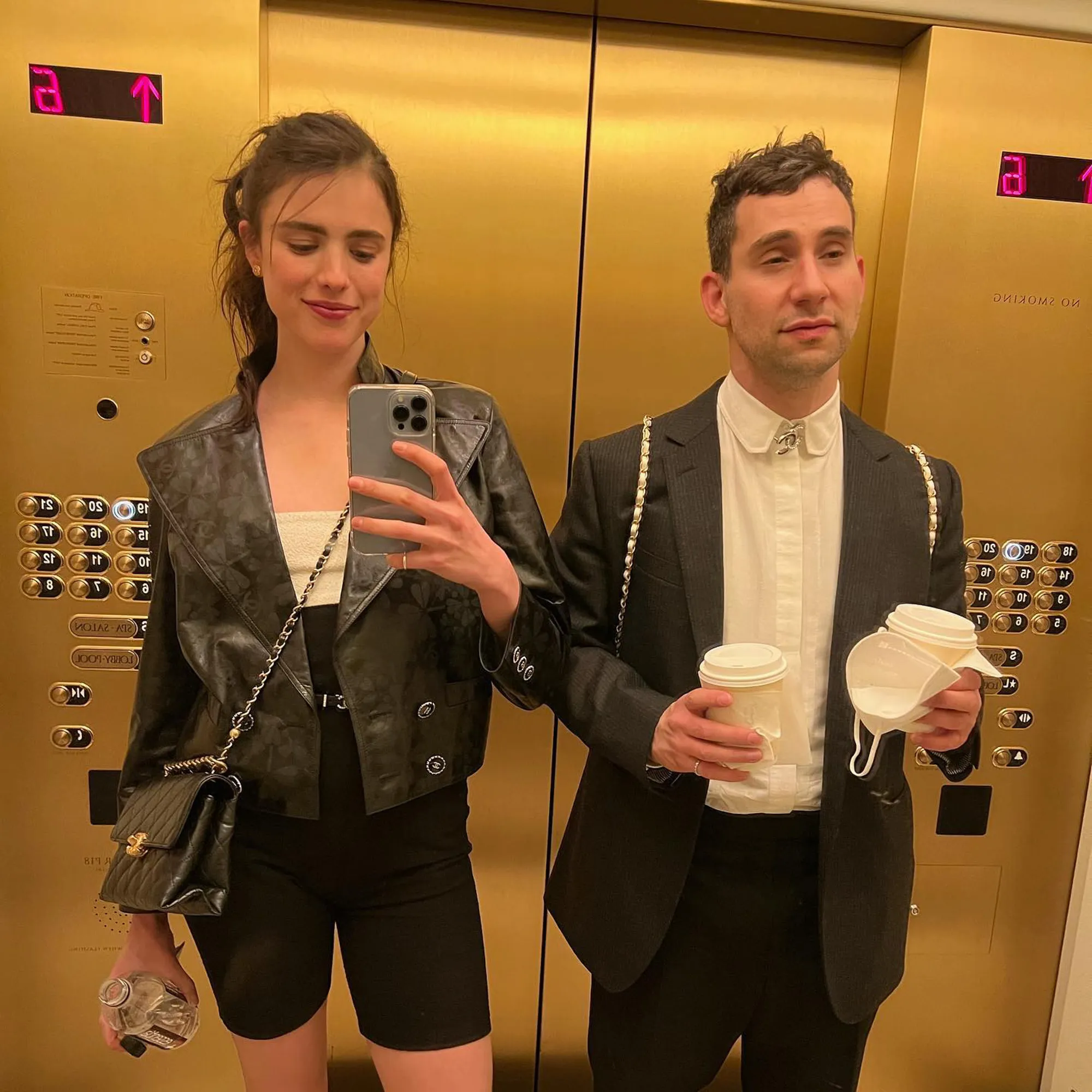 Margaret Qualley takes a selfie with Jack Antonoff in a golden elevator.