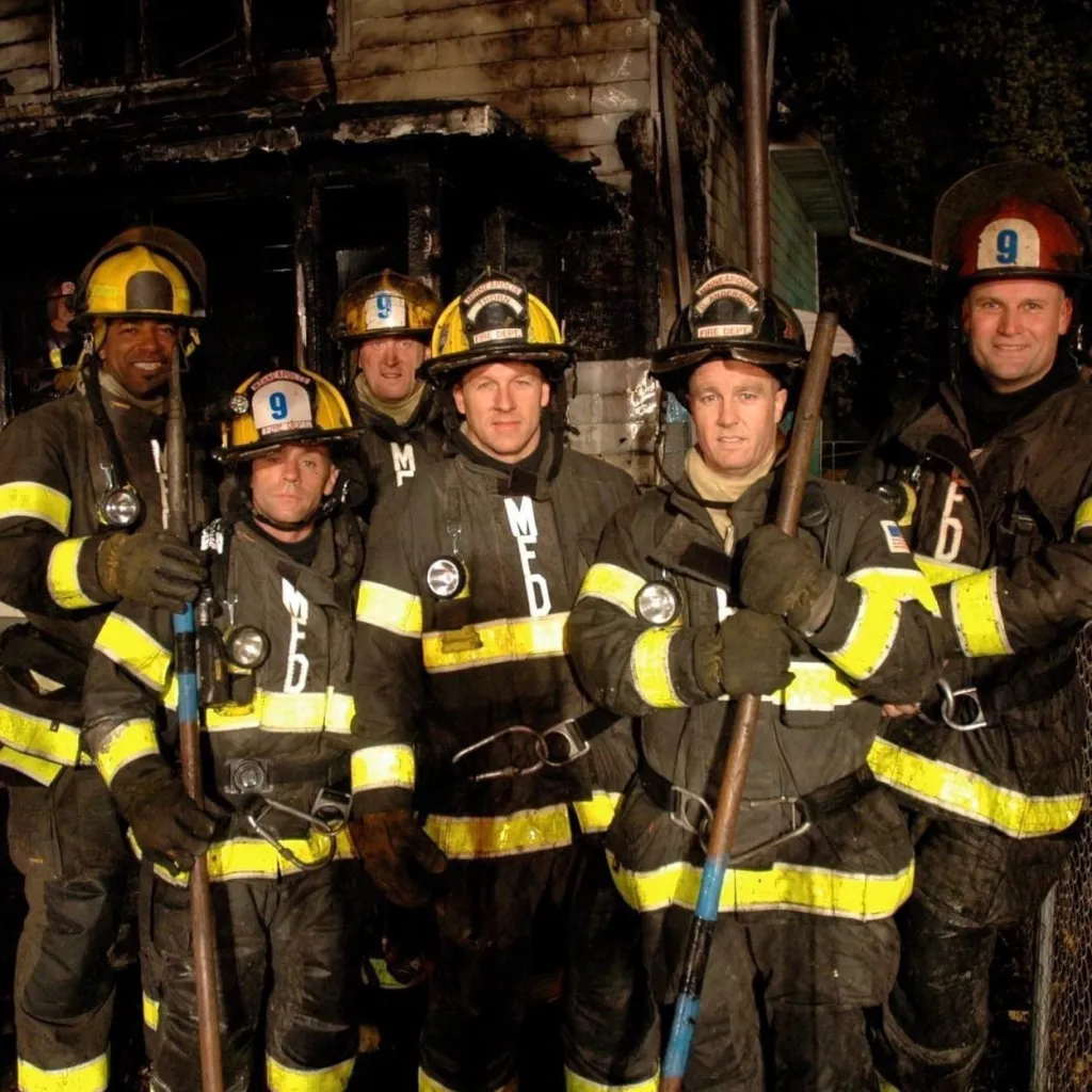 Darrin Gregory, Jake LaFerriere, Brad Bremseth, Shane Thorn, Dean Anderson, and Denny Mack in firefighter gear outside Fire Station 11.