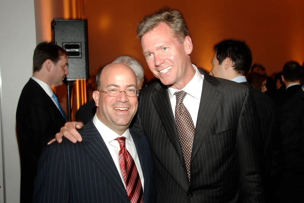 Jeff Zucker and Chris Hansen posing together at a cocktail party.