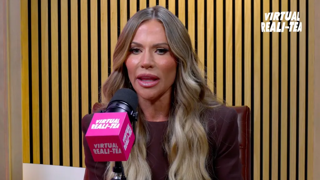 Jenn Pedranti speaking into a microphone with 