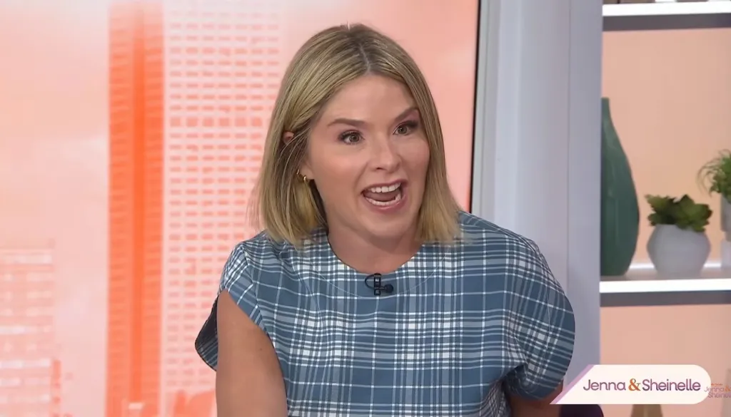 Jenna Bush Hager speaking with an open mouth while wearing a blue and white plaid top.