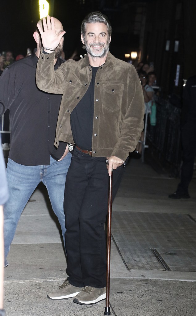 Jim Curtis waving while holding a cane.