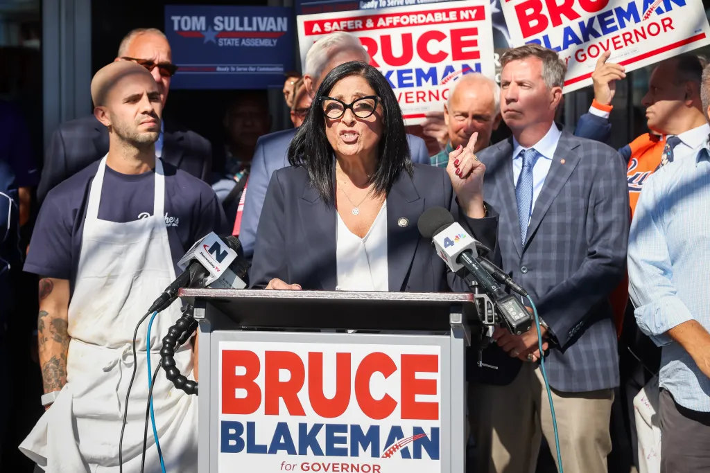 NYC Council member Joann Ariola speaking at a campaign event, with Tom Sullivan, Republican candidate for NY State Assembly, standing to her right.