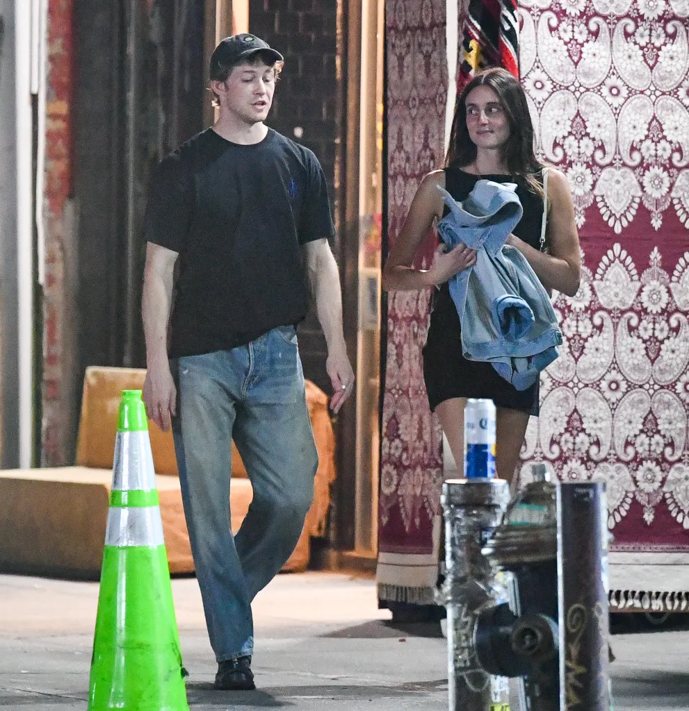 Joe Alwyn and Mary Beth Barone walking together in New York City.