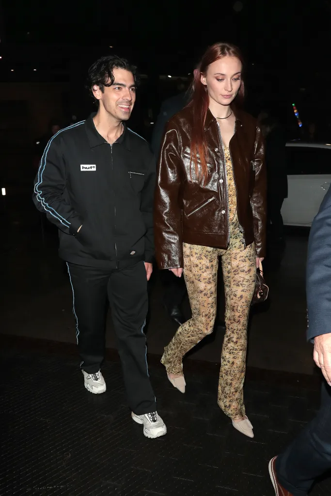 Joe Jonas and Sophie Turner walking outside at night.