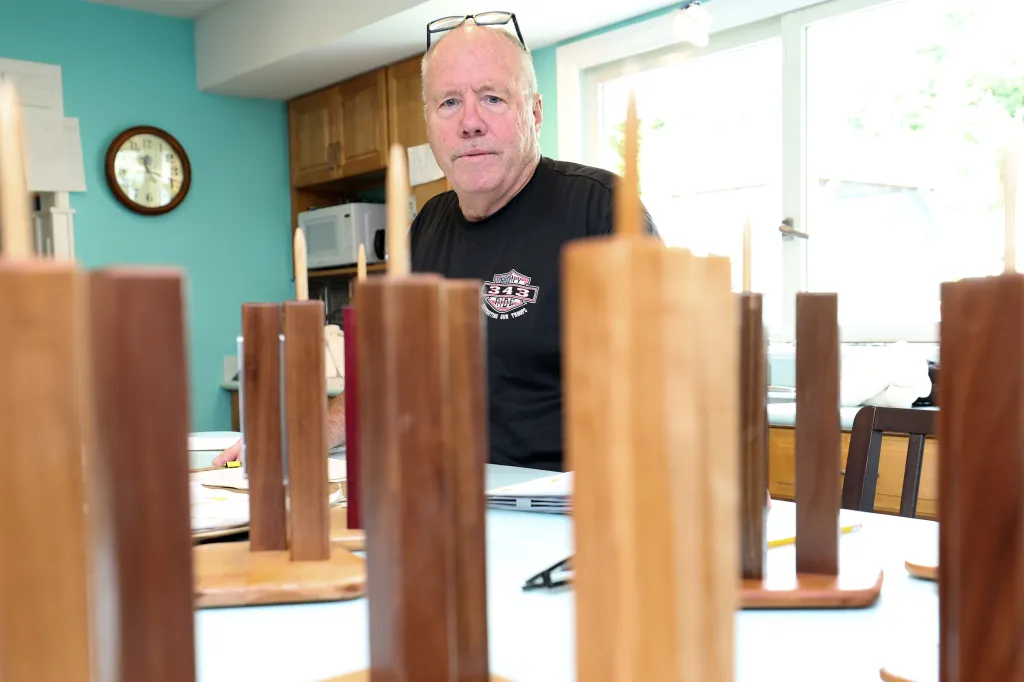 Retired FDNY 9/11 first responder John Ricketts builds models of the twin towers with recovered metal from the site at his Long Island home on Thursday, August 27, 2026. Ricketts shares the completed models with his friends.