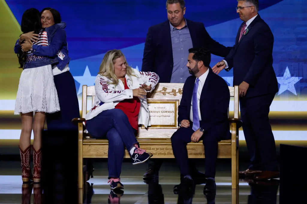 U.S. Rep. Mike Lawler sits on a memorial bench with public safety advocate Jessica Gorman on stage at the Republican National Midterm Convention, joined by Tom and Madelon Gorman.