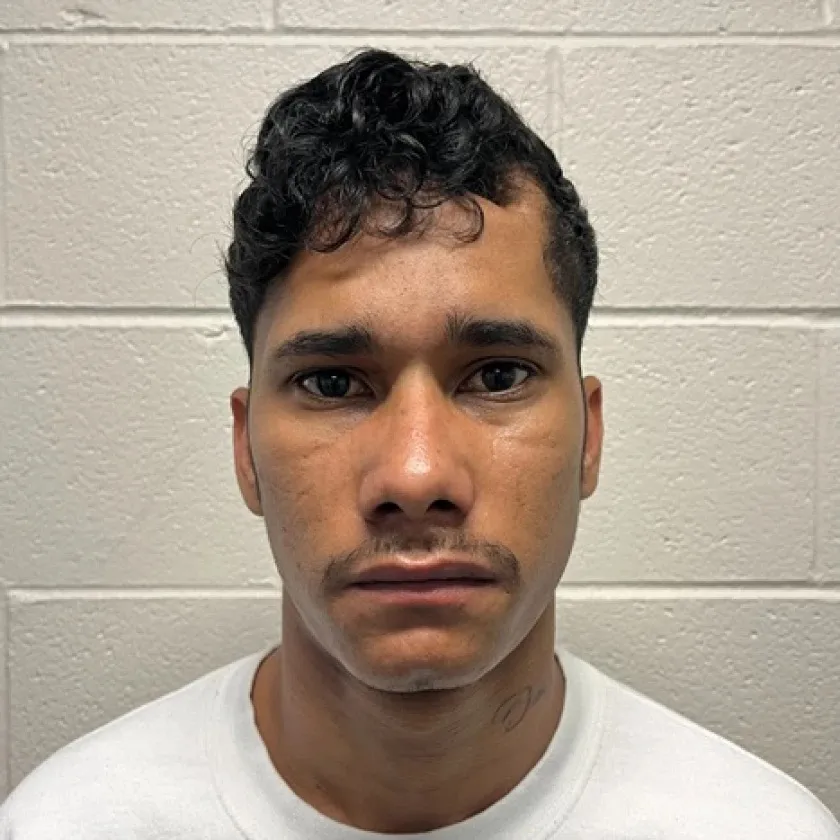 A headshot of Jose Medina against a white brick wall.