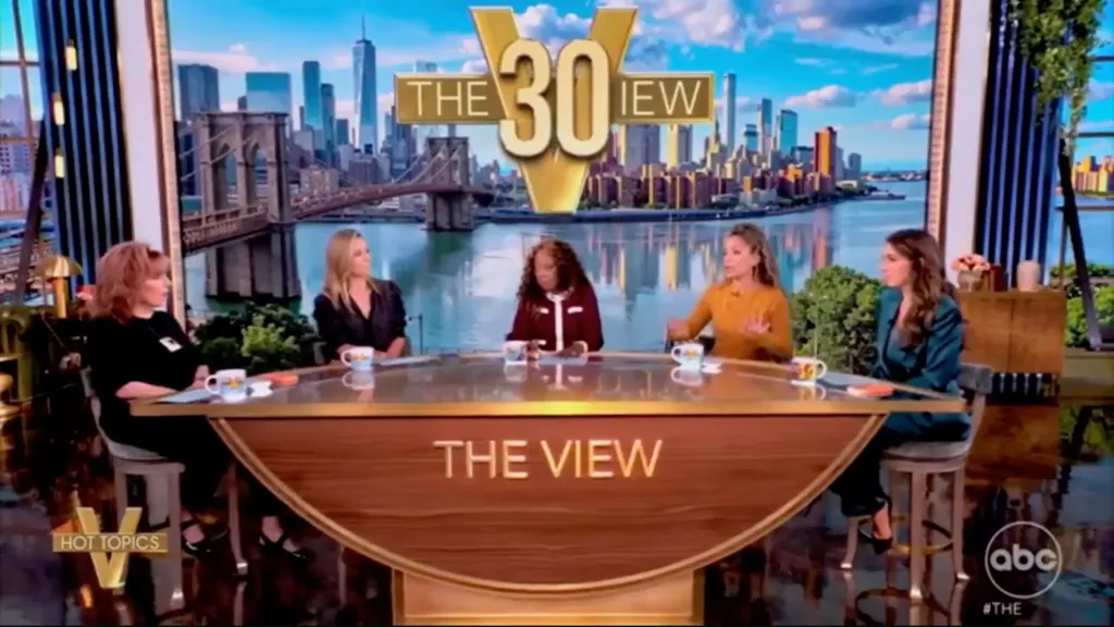Joy Behar and three other women seated around a table with 
