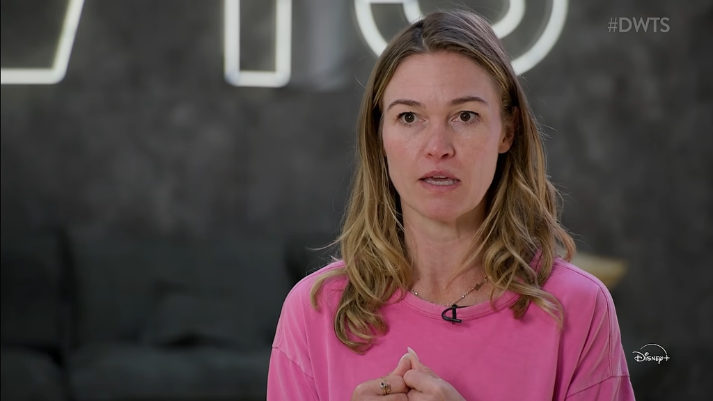 Julia Stiles wearing a pink shirt in DWTS rehearsal.