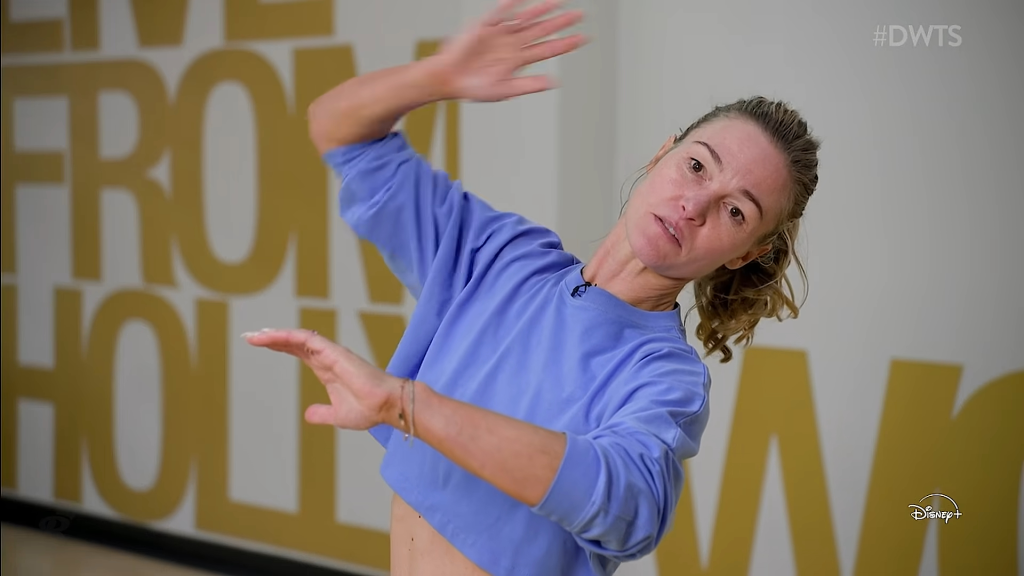 Julia Stiles in a purple sweatshirt during a rehearsal.
